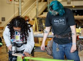 Student welding with teacher