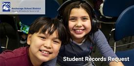 two students smiling at the camera