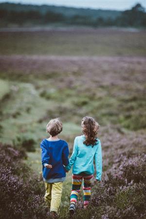 Children walking through a field