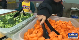  Students getting carrots and broccoli. 