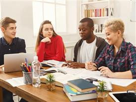  students sitting at table studying