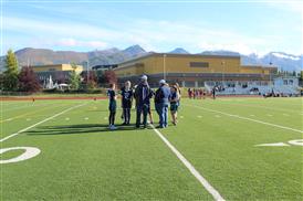  Flag football team talking to coaches in front of ERHS